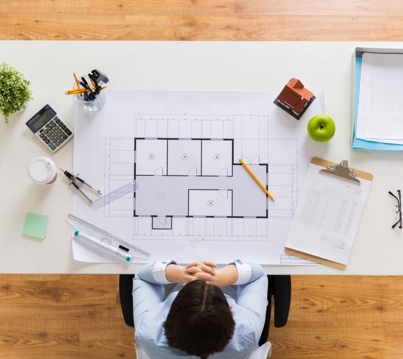 architect-with-house-blueprint-at-office-PDQRLAX